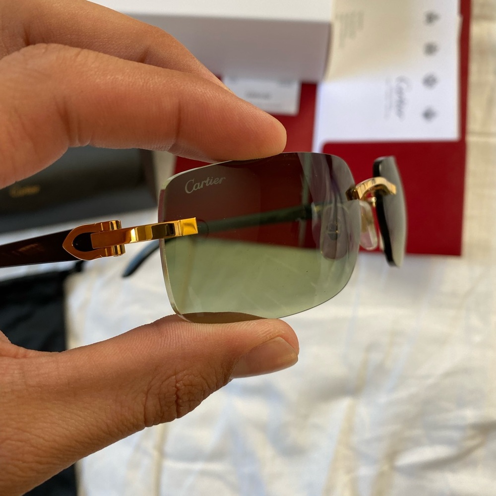 Cartier black Buffalo with green lens